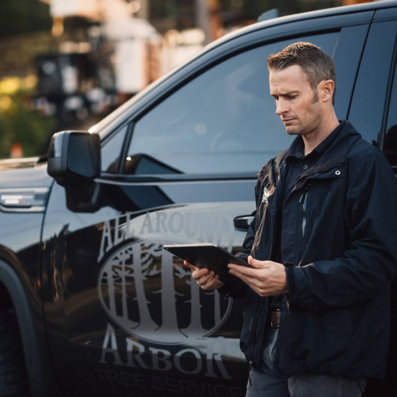 A person in a police uniform standing next to a car.