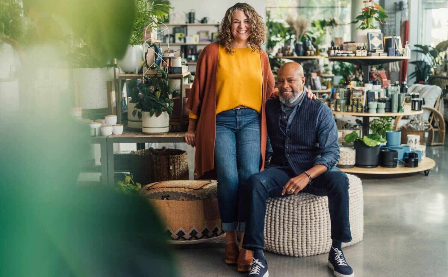 Retail business owners sitting at a table smiling