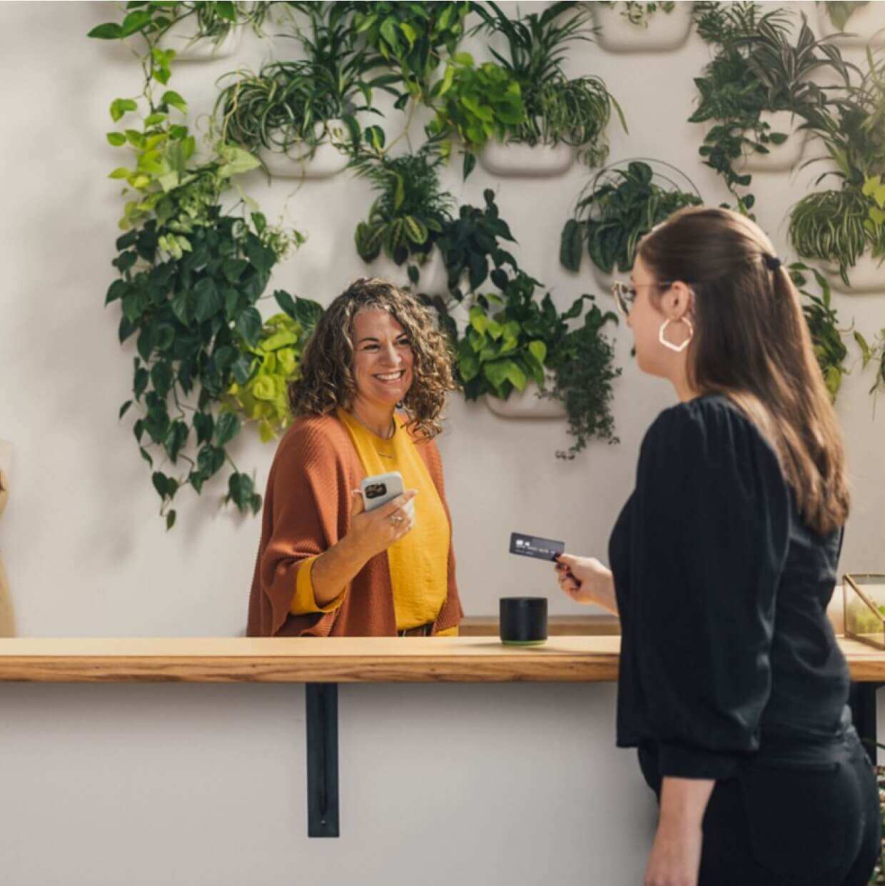 Retail business owner with a customer using QuickBooks POS system