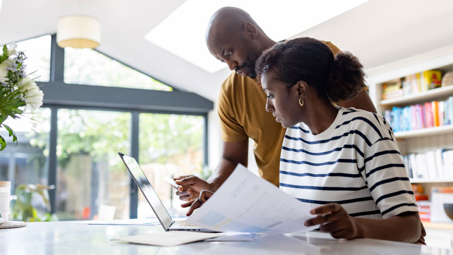 Small business owners review tax files and documents.
