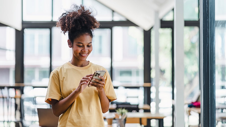 A person holding a smart phone in her hands.