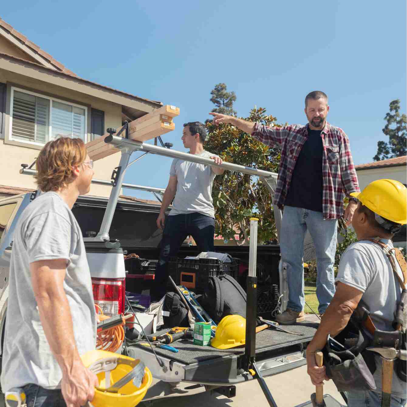Construction business owner talking with employees
