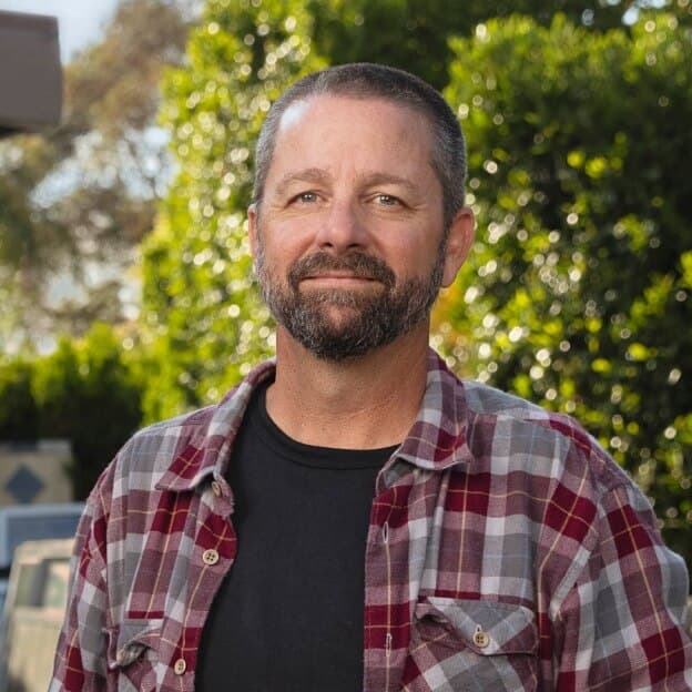 Photo of a person, outside, smiling at the camera.