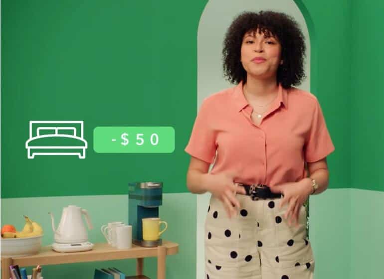 A photo of a person standing and using their hands to explain something. Overlayed on top the photo is an illustration of a bed with the cost: -$50 displayed.