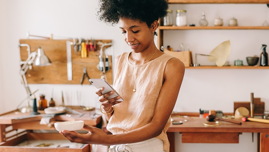 A small business owner taking a photo of her product to help with her advertising strategy.