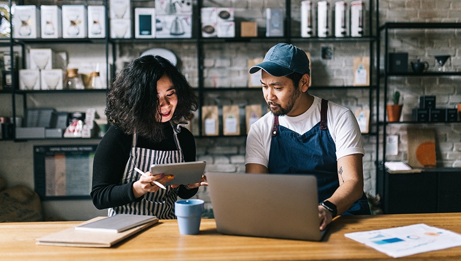 An image of small business owners researching small business benefits.