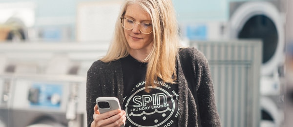 Female business owner collaborating on a mobile device