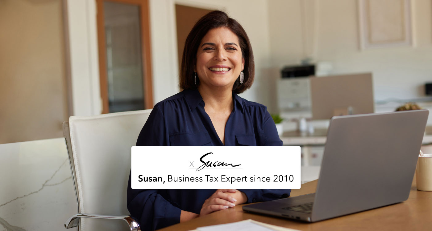 A QuickBooks business tax expert is sitting at a desk in front of an open laptop computer