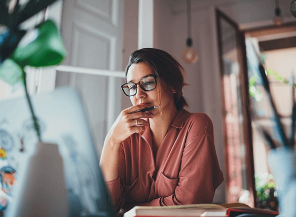 Woman looking at laptop thinking