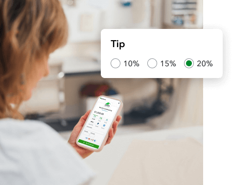 Woman holding a phone to pay an invoice online deciding what tip to leave. 