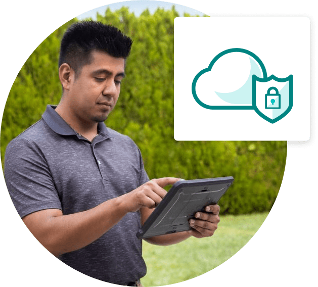 Man working on tablet. A graphic overlay shows a cloud security icon.