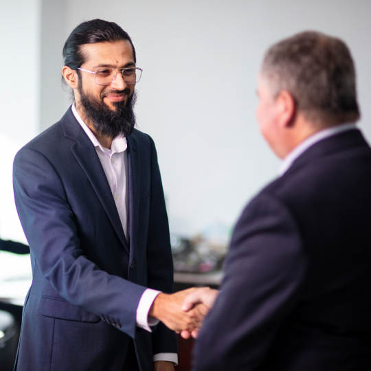 Businessmen greeting each other with handshake.